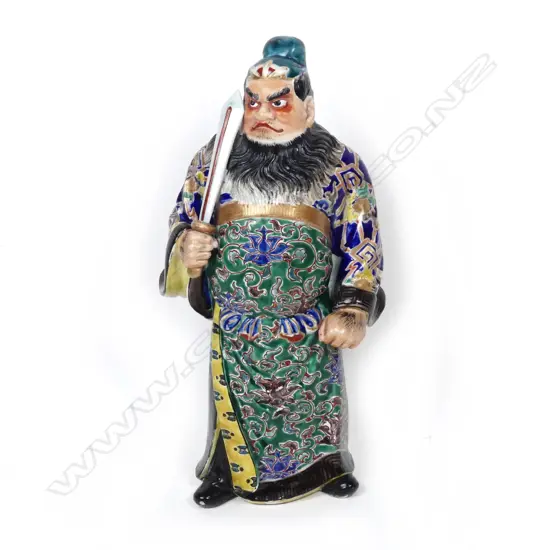 A Chinese porcelain figure of a standing warrior god