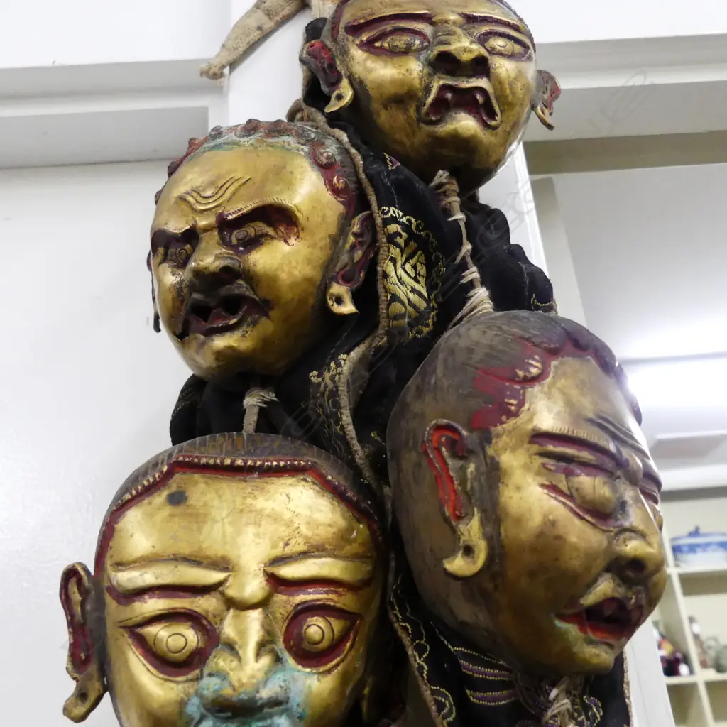 An uncommon Tibetan lama’s collar of thirteen brass masks Image 1++