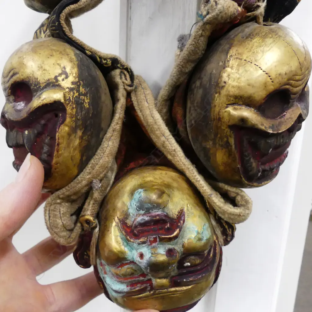 An uncommon Tibetan lama’s collar of thirteen brass masks Image 1++