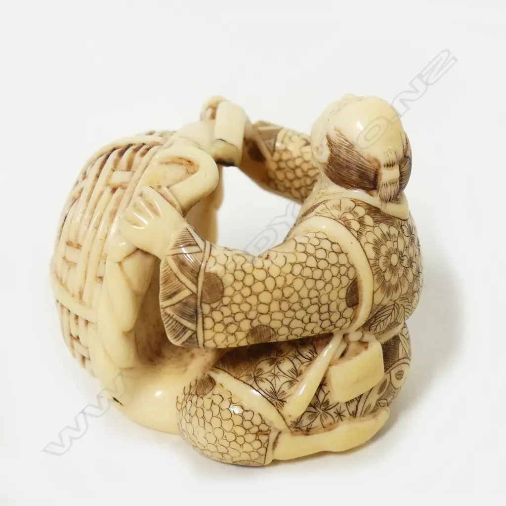 A Japanese ivory okimono of a basket maker Image 1++
