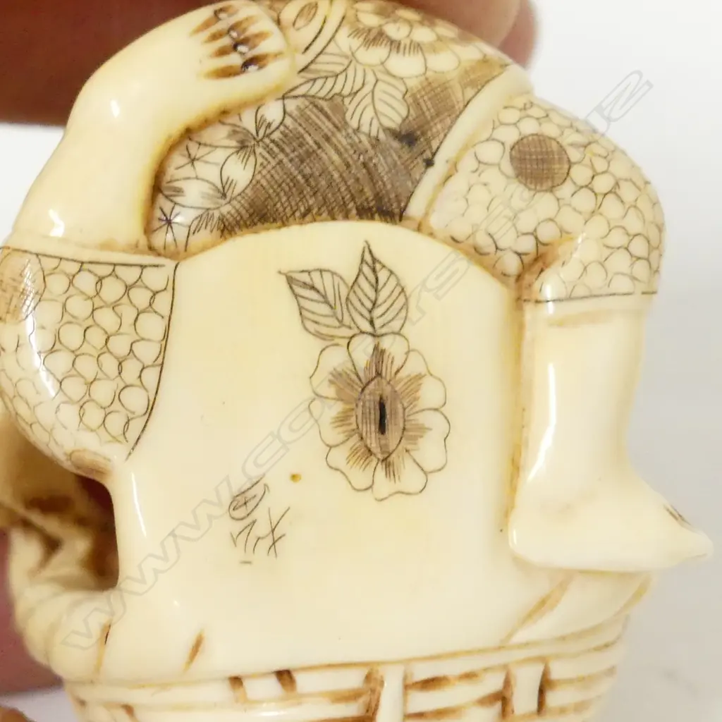 A Japanese ivory okimono of a basket maker Image 1++