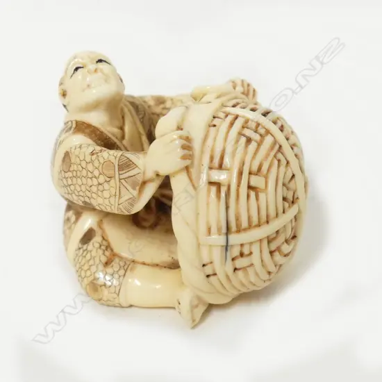 A Japanese ivory okimono of a basket maker