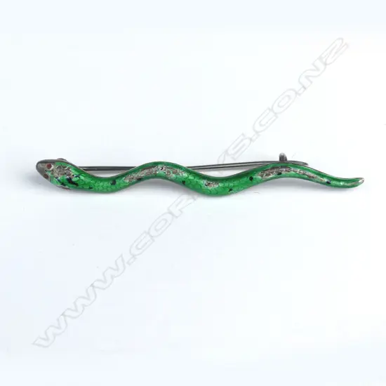 A silver and green enamel snake brooch