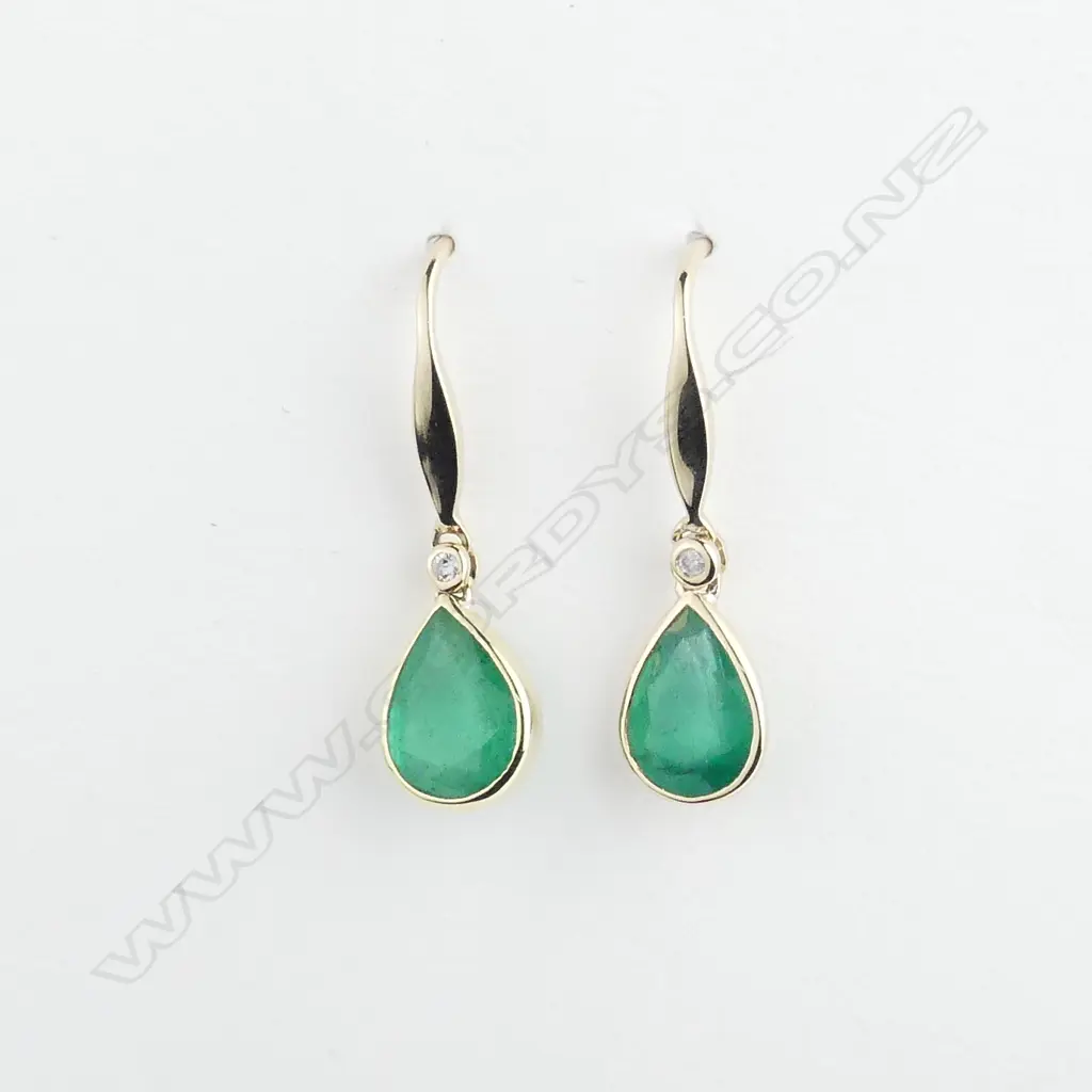 A pair of 14ct gold emerald and diamond earrings Image 1++
