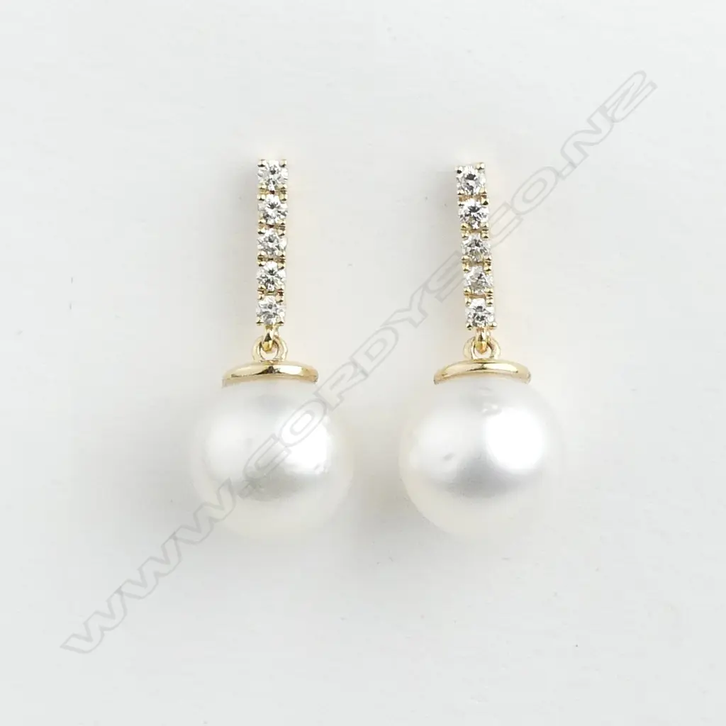 A pair of 14ct gold pearl and diamond drop earrings Image 1++