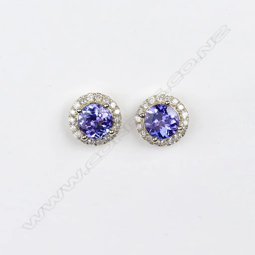 A pair of 14ct. gold tanzanite and diamond stud earrings Image 1++