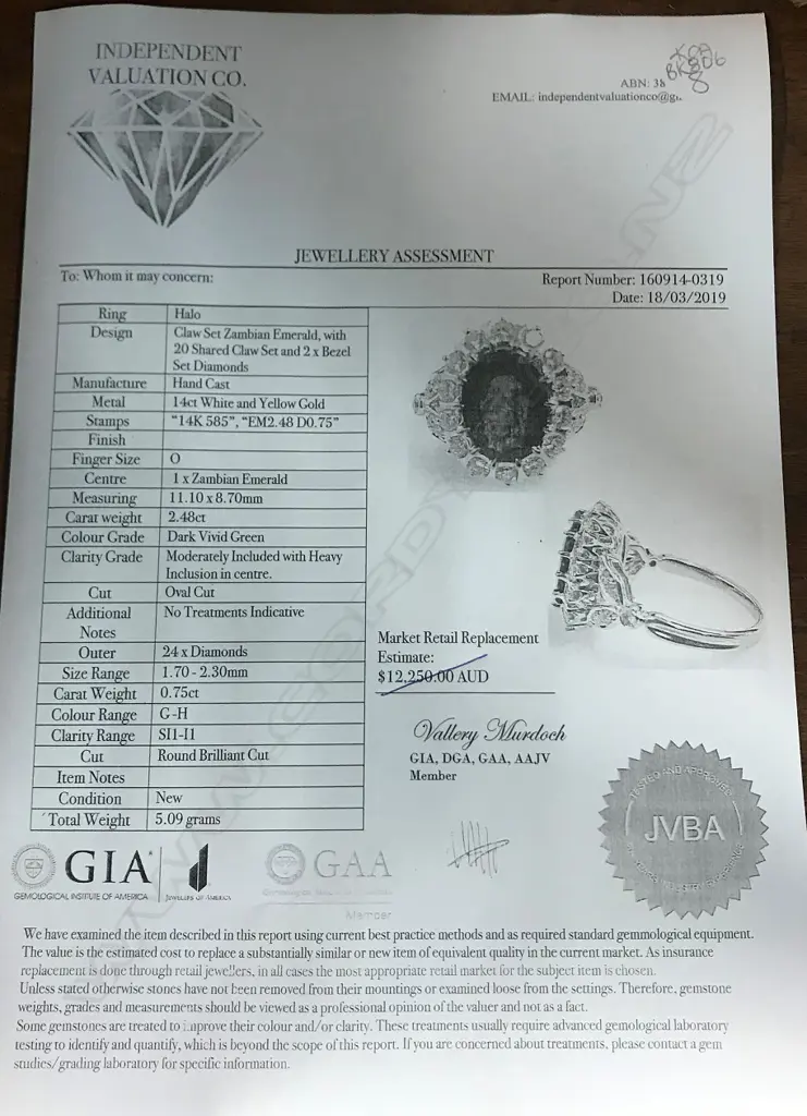 A 14ct white gold emerald and diamond ring Image 1++