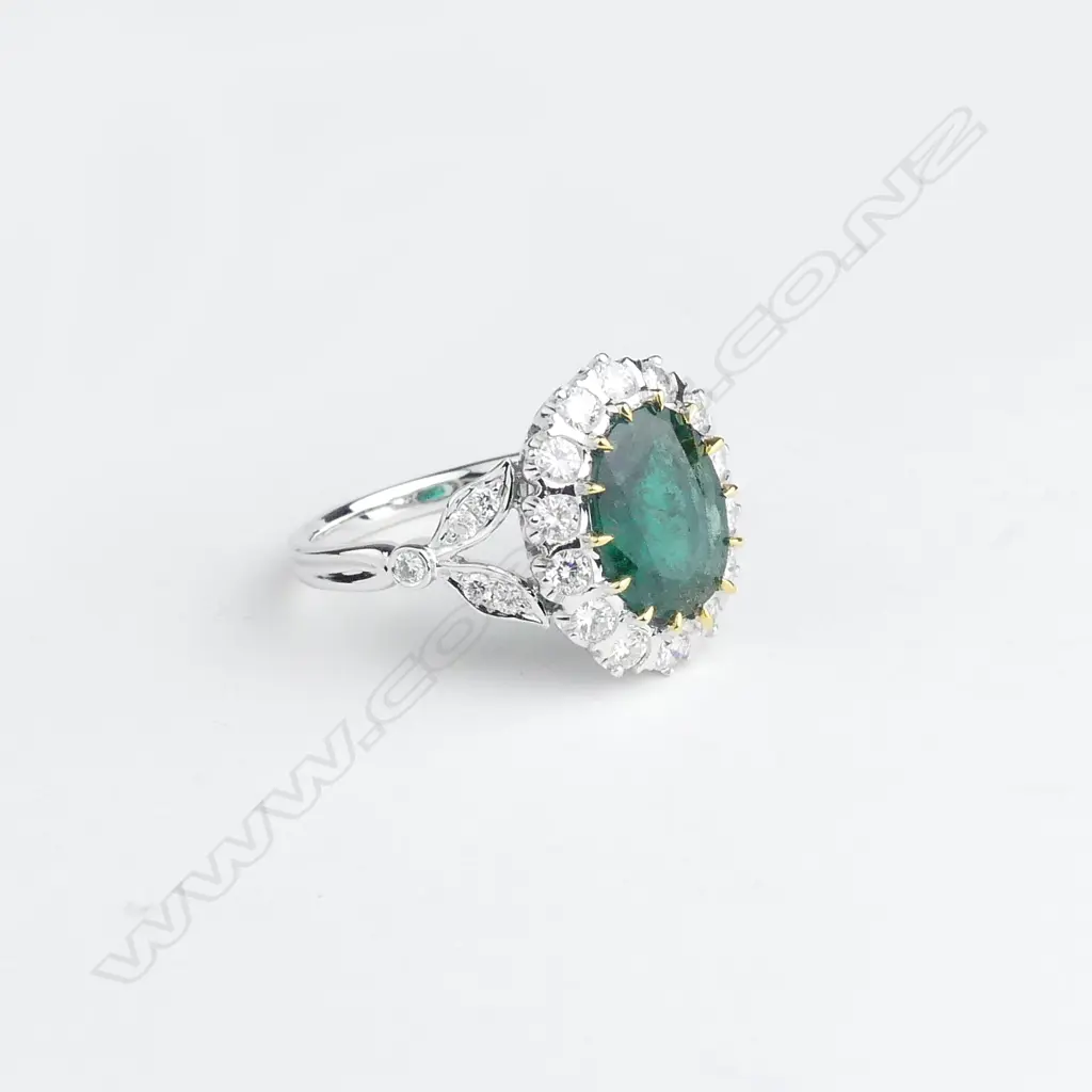 A 14ct white gold emerald and diamond ring Image 1++