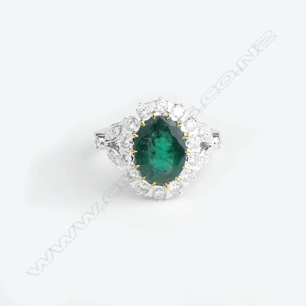 A 14ct white gold emerald and diamond ring Image 1++