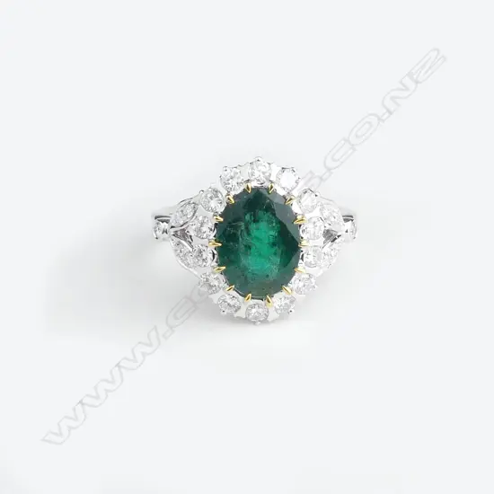 A 14ct white gold emerald and diamond ring