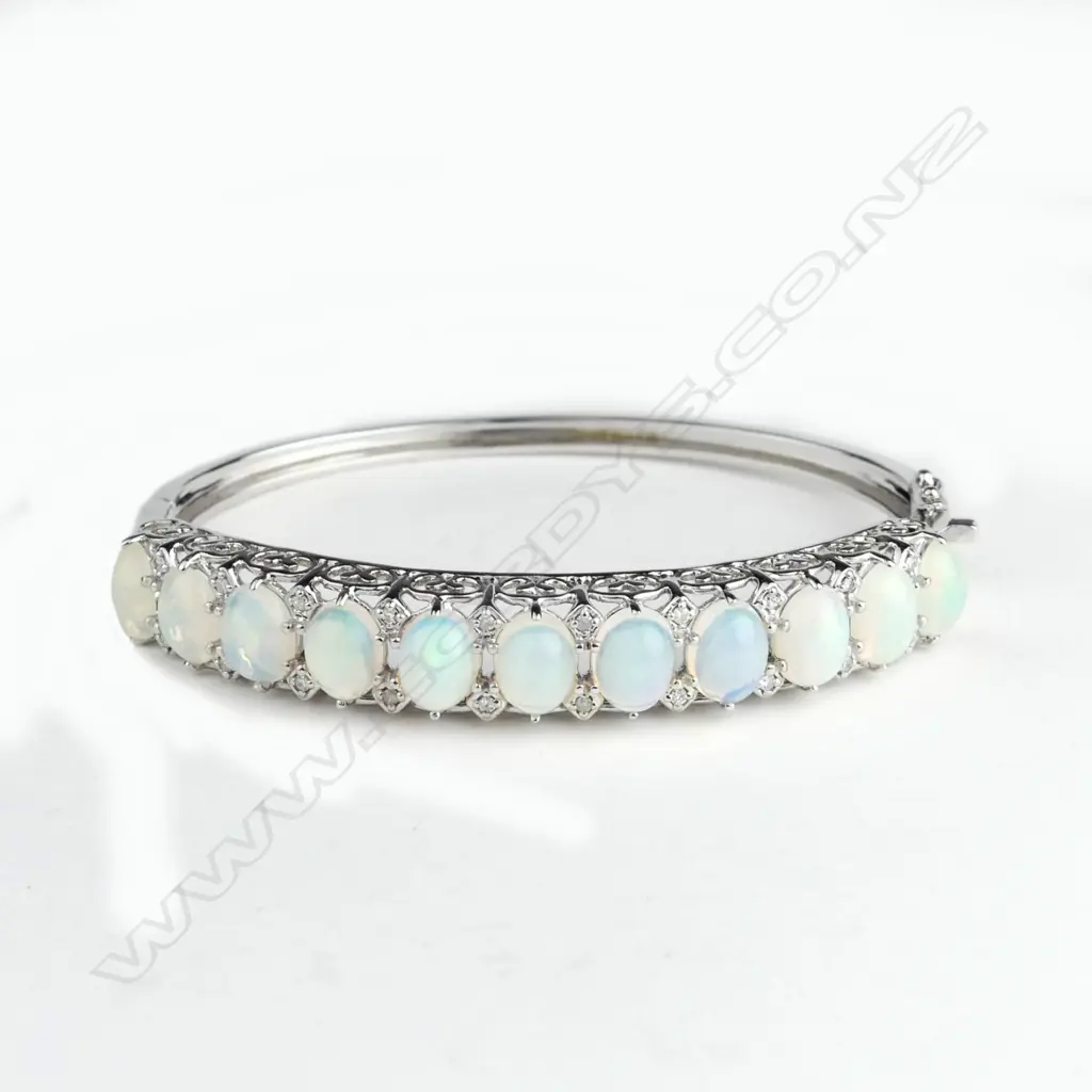 A 14ct white gold opal and diamond bangle Image 1++