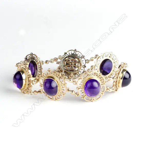 A mid-20thC lady's 9ct. rose gold and amethyst panelled bracelet