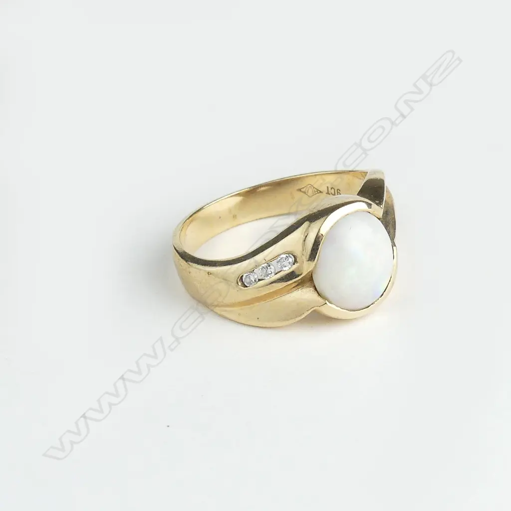 A 9ct gold opal and diamond ring Image 1++