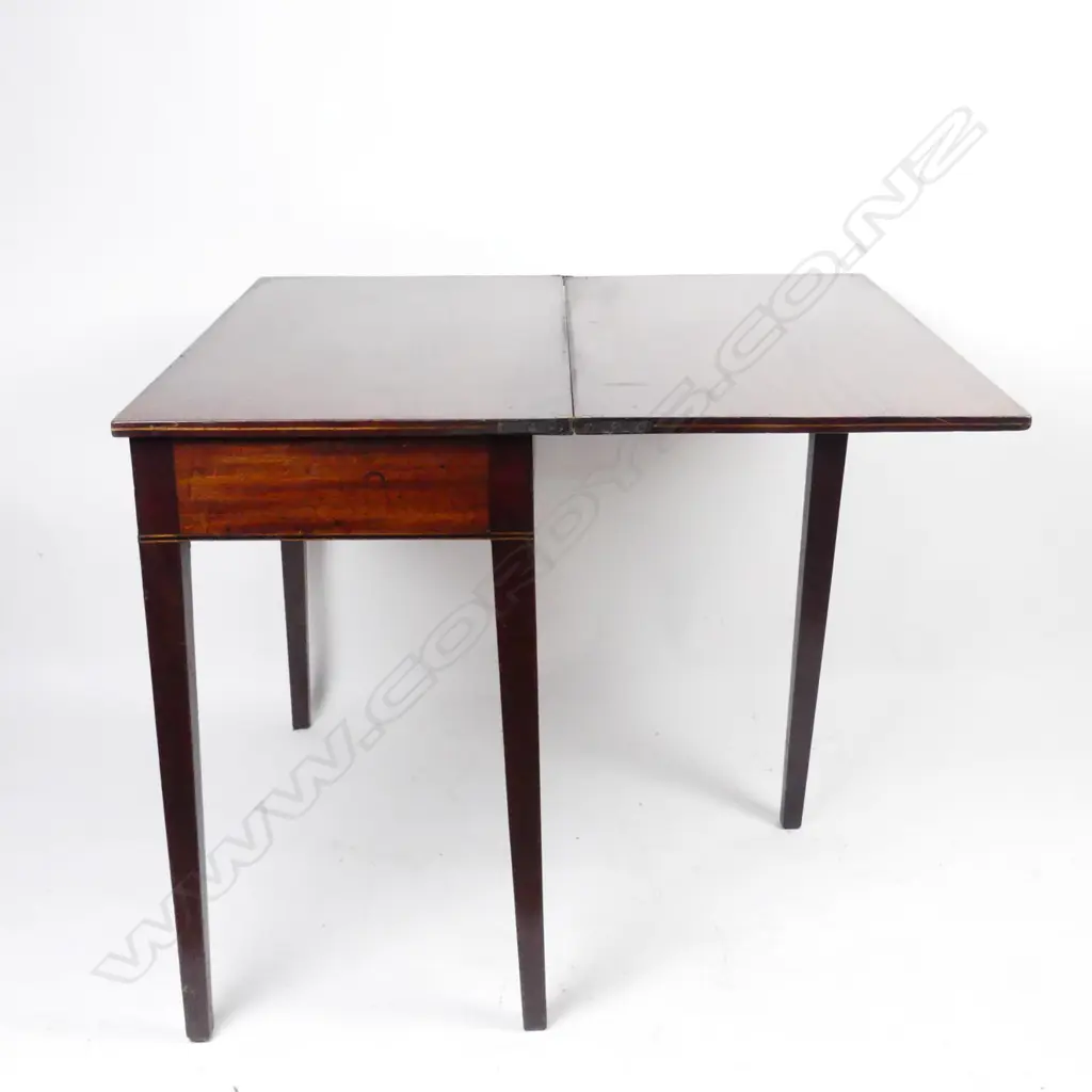 A George III mahogany fold-over tea table Image 1++