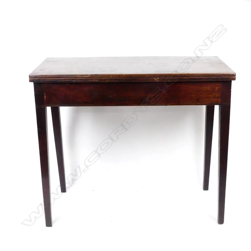 A George III mahogany fold-over tea table Image 1++