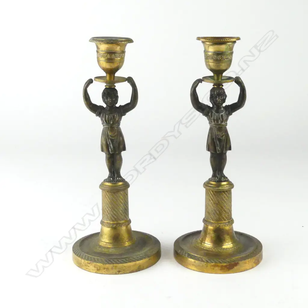 A pair of parcel gilt bronze candlesticks Image 1++