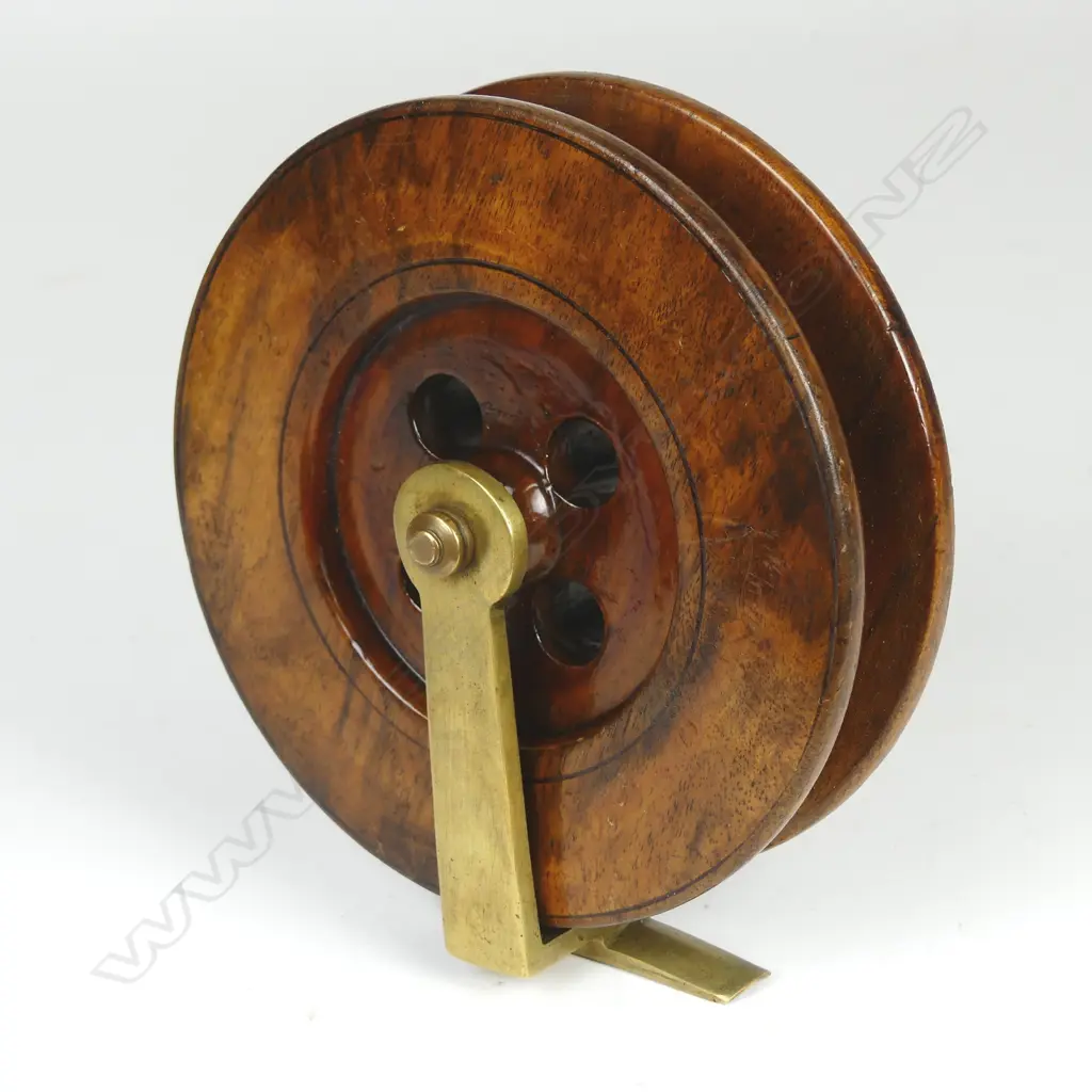 A wood and brass fishing reel Image 1++