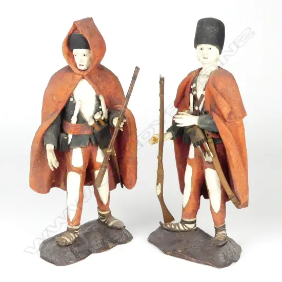 A pair of Eastern European carved wood and bone figures of fighters