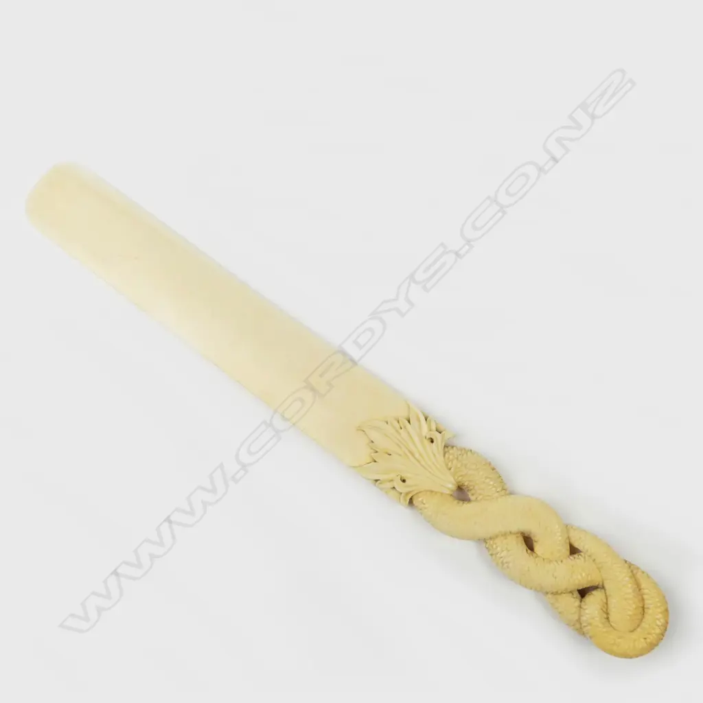A 19thC finely carved ivory contorted snake paper knife Image 1++