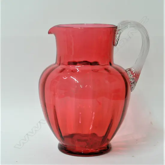 A Victorian cranberry glass jug