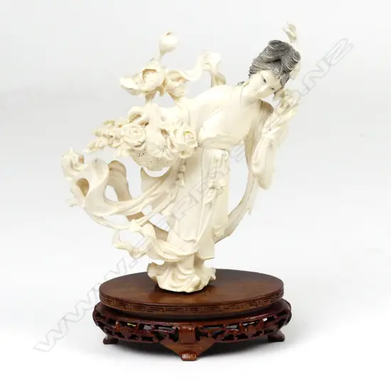A Chinese ivory figure of a woman with basket of flowers
