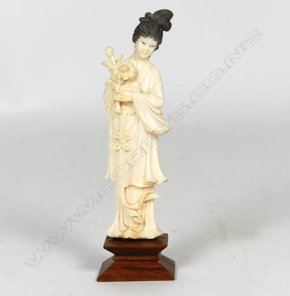 A Chinese carved ivory figure of a woman Image 1++
