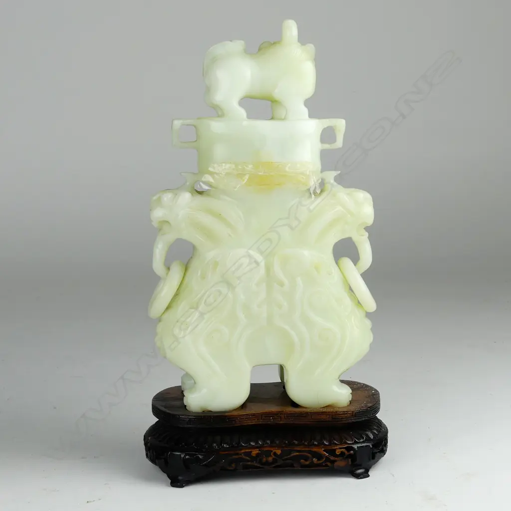 A Chinese carved pale jade urn and cover Image 1++