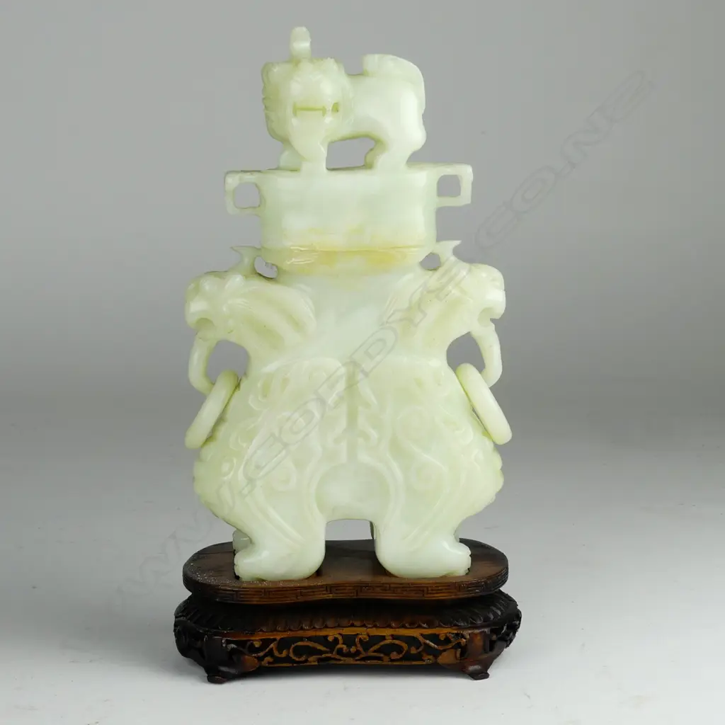 A Chinese carved pale jade urn and cover Image 1++