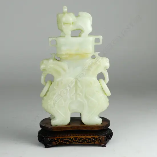 A Chinese carved pale jade urn and cover