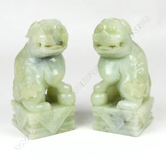 A pair of large Chinese pale jade foo dogs