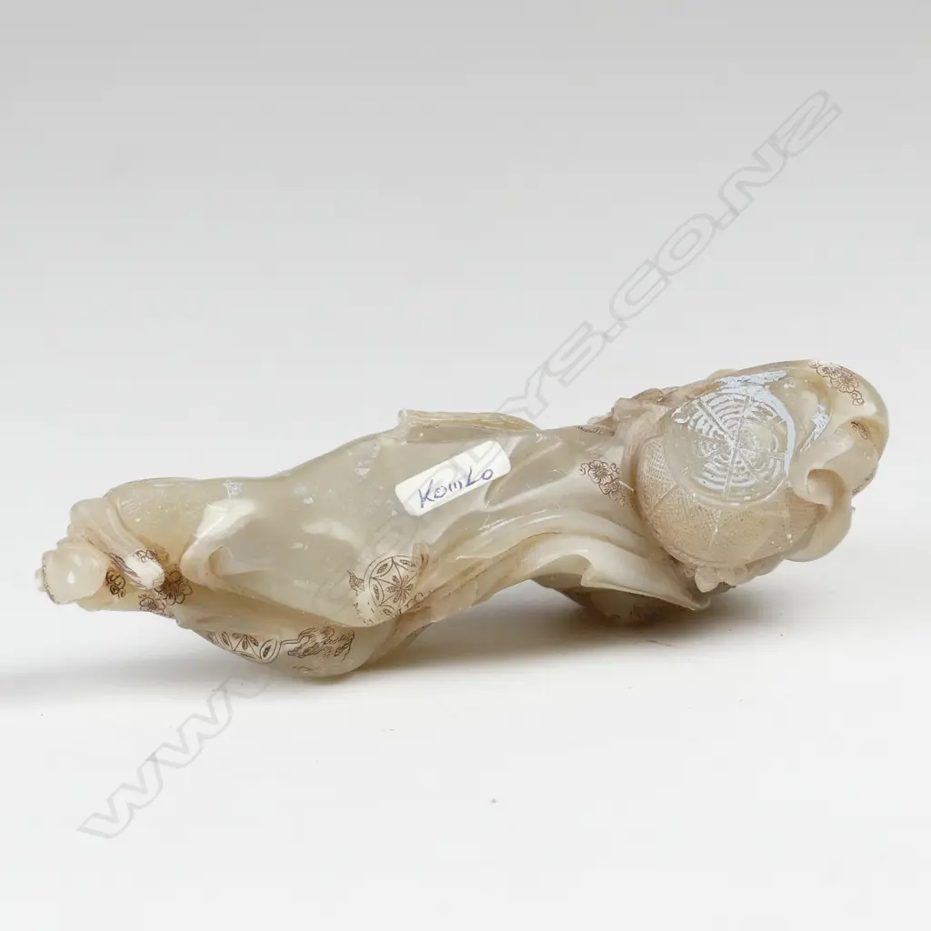 A Chinese carved jade reclining figure of a woman Image 1++