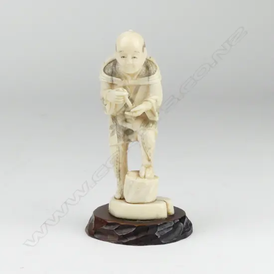 A Japanese marine ivory figure of an agricultural worker