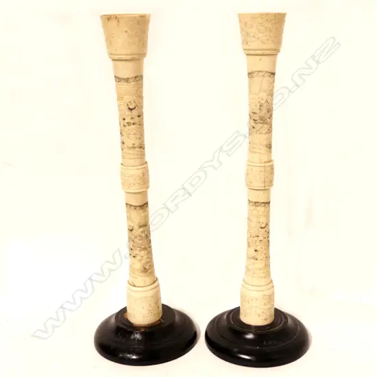 A pair of Japanese carved bone candlesticks