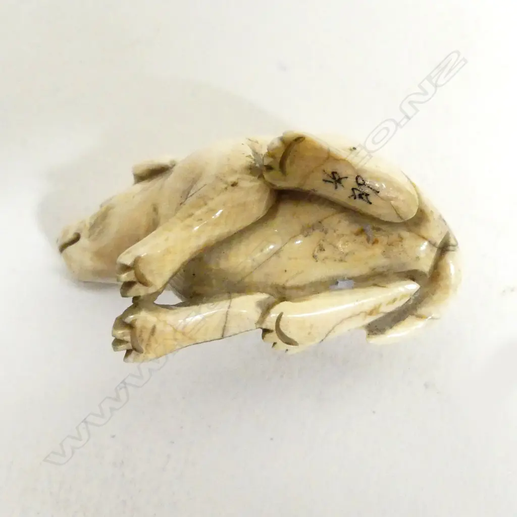 A small ivory netsuke of a puppy Image 1++
