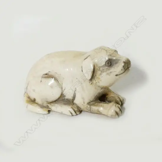 A small ivory netsuke of a puppy
