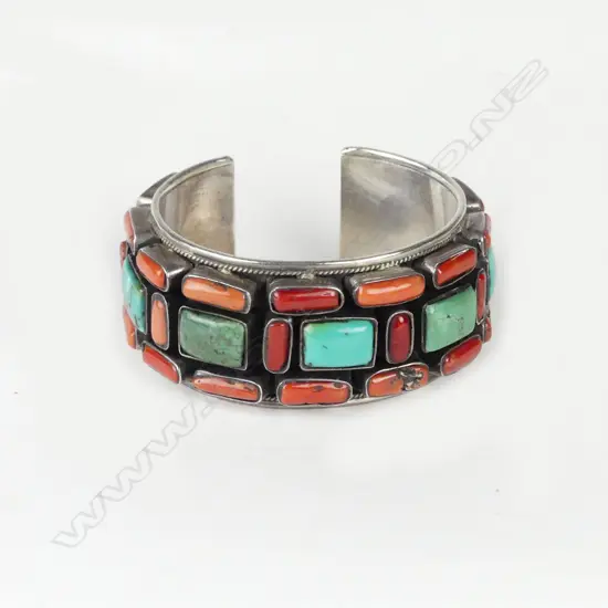 A vintage Afghani silver coral and turquoise cuff bangle