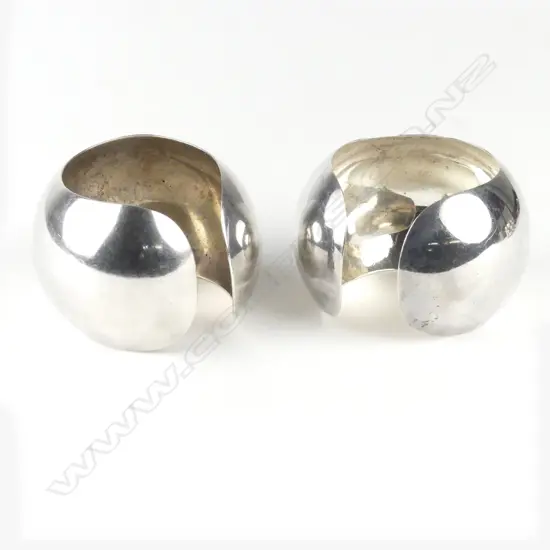 A pair of vintage Mexican silver wide domed cuff bangles