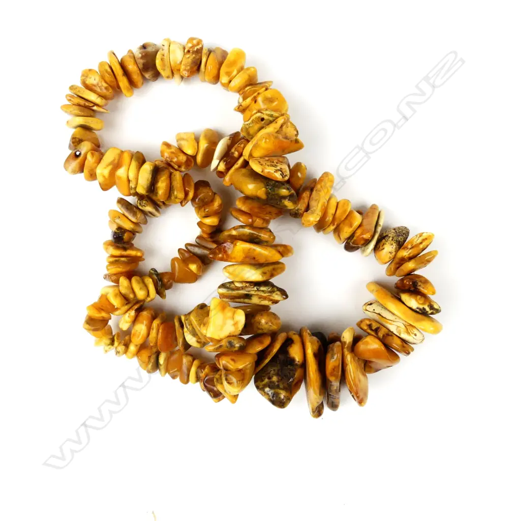 A long graduated polished nugget amber necklace Image 1++