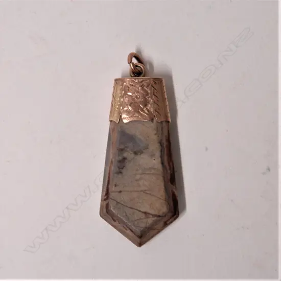 A late 19thC 9ct. rose gold mounted petrified wood fob pendant