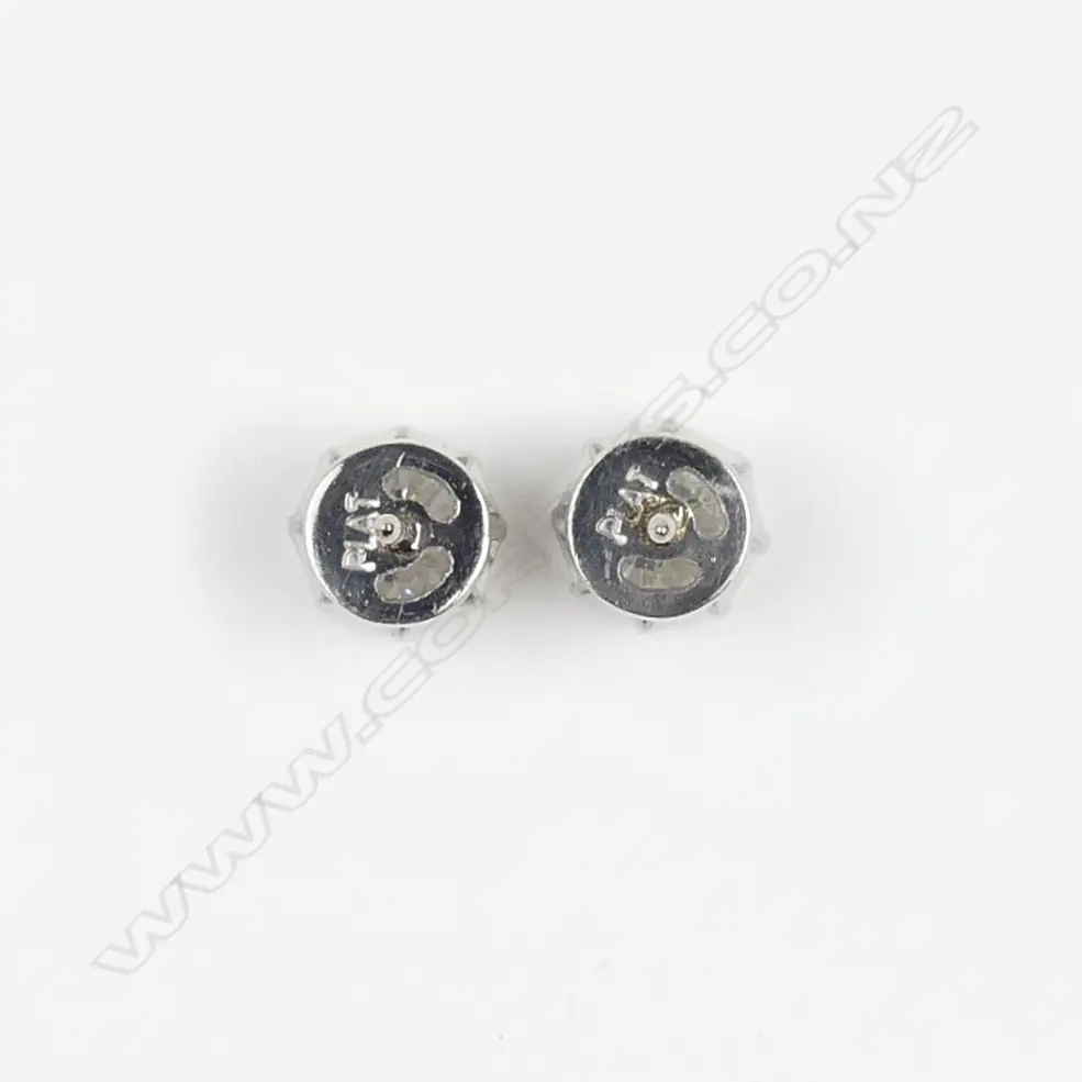 A pair of platinum and 18ct white gold 1ct ea. diamond stud earrings Image 1++