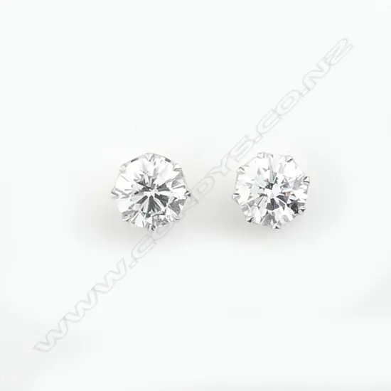 A pair of platinum and 18ct white gold 1ct ea. diamond stud earrings