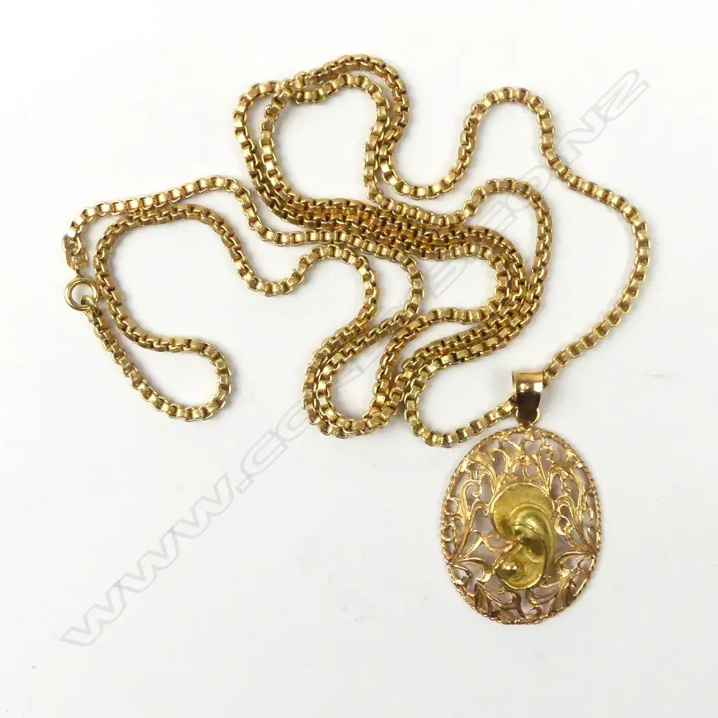 An 18ct gold pendant and chain Image 1++