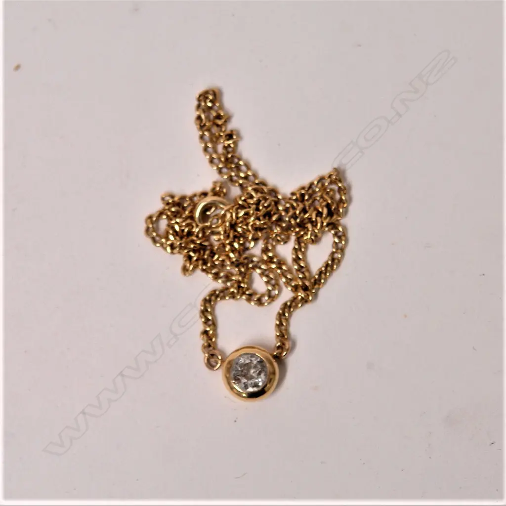 A modern 18ct. yellow gold and diamond pendant necklace Image 1++