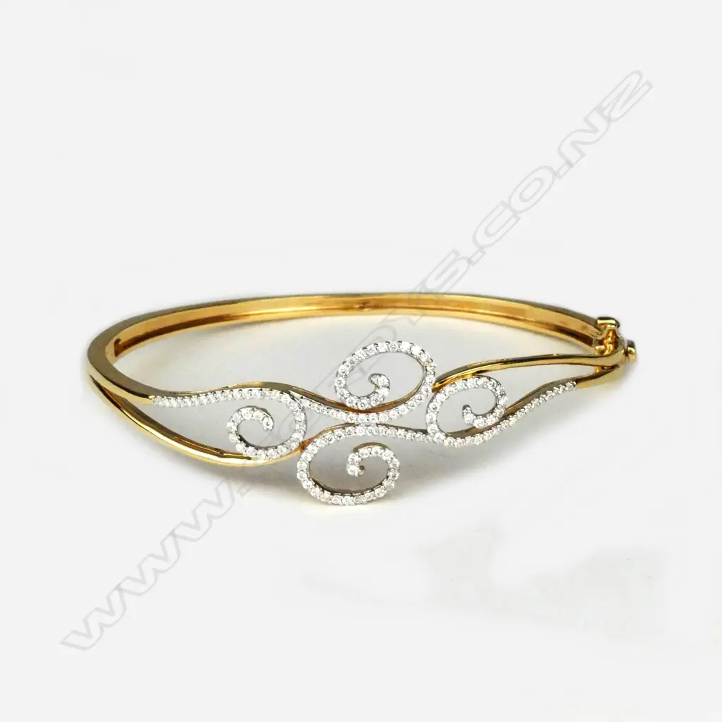 An 18ct gold and diamond hinged bangle Image 1++