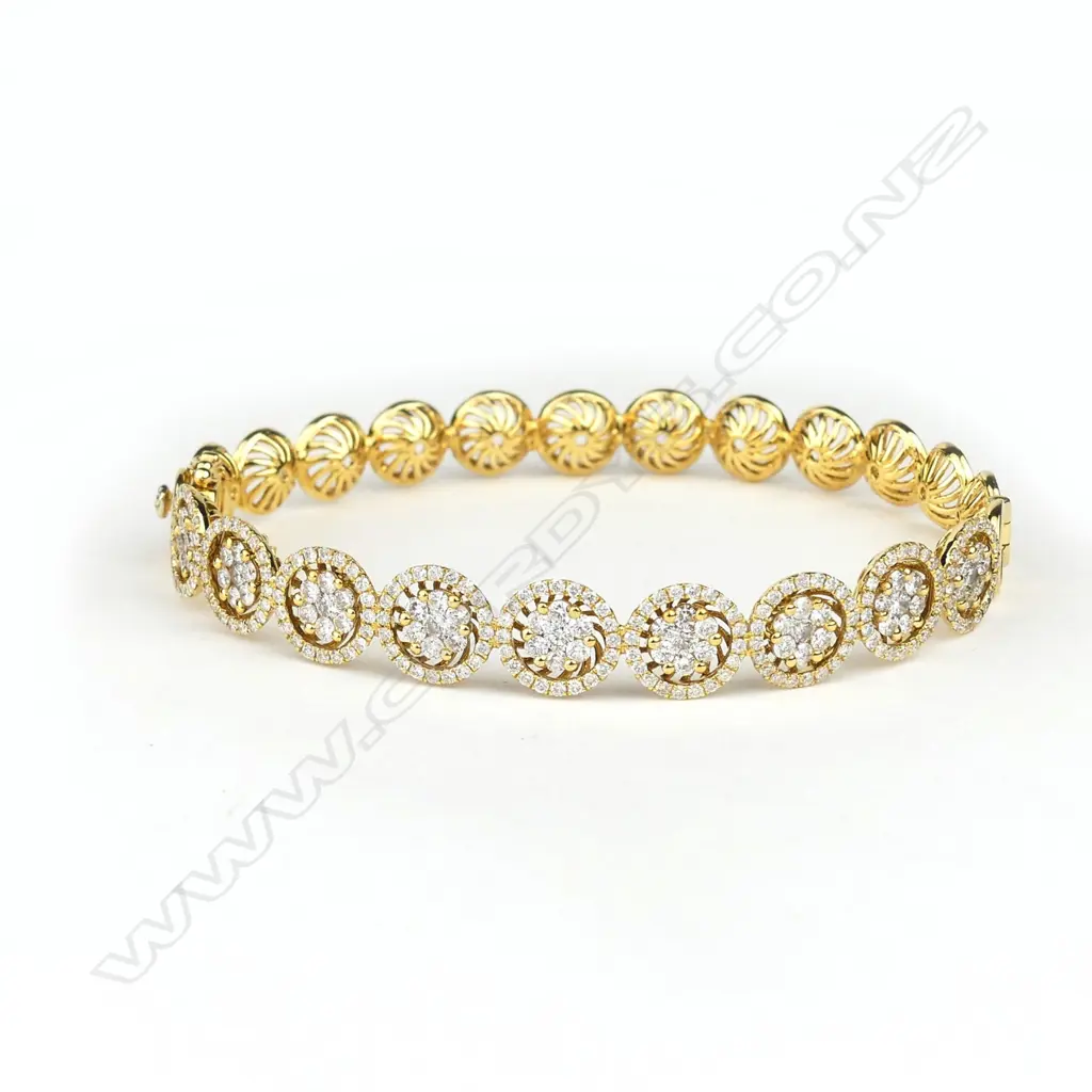 An 18ct gold and diamond hinged bangle Image 1++