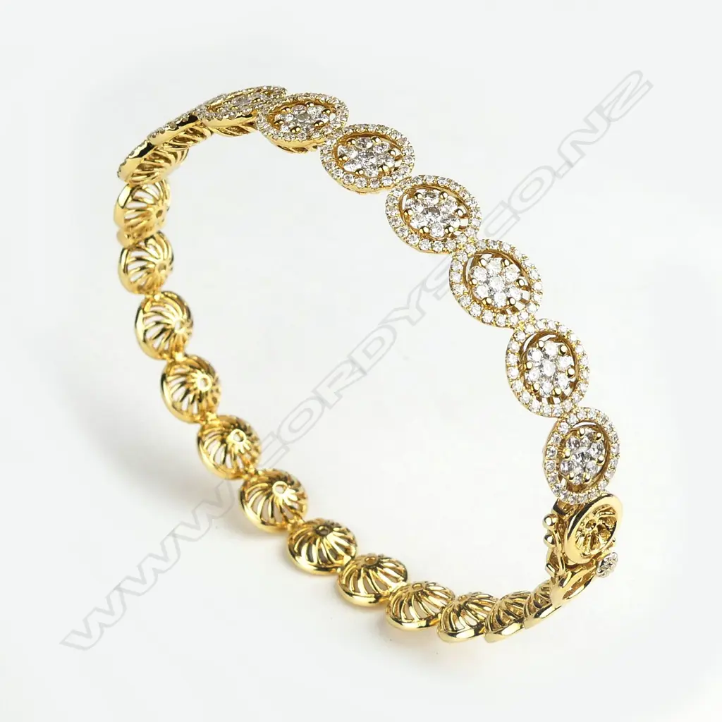 An 18ct gold and diamond hinged bangle Image 1++