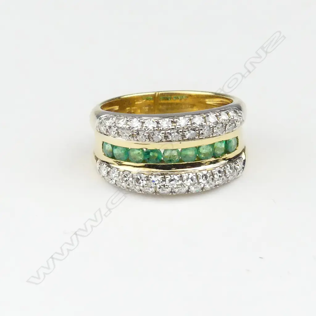 An 18ct gold diamond and emerald dress ring Image 1++