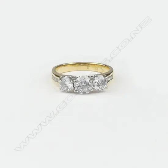 A good 18ct yellow & white gold ladies three stone diamond ring