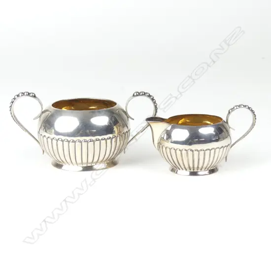 A late Victorian silver cream and sugar