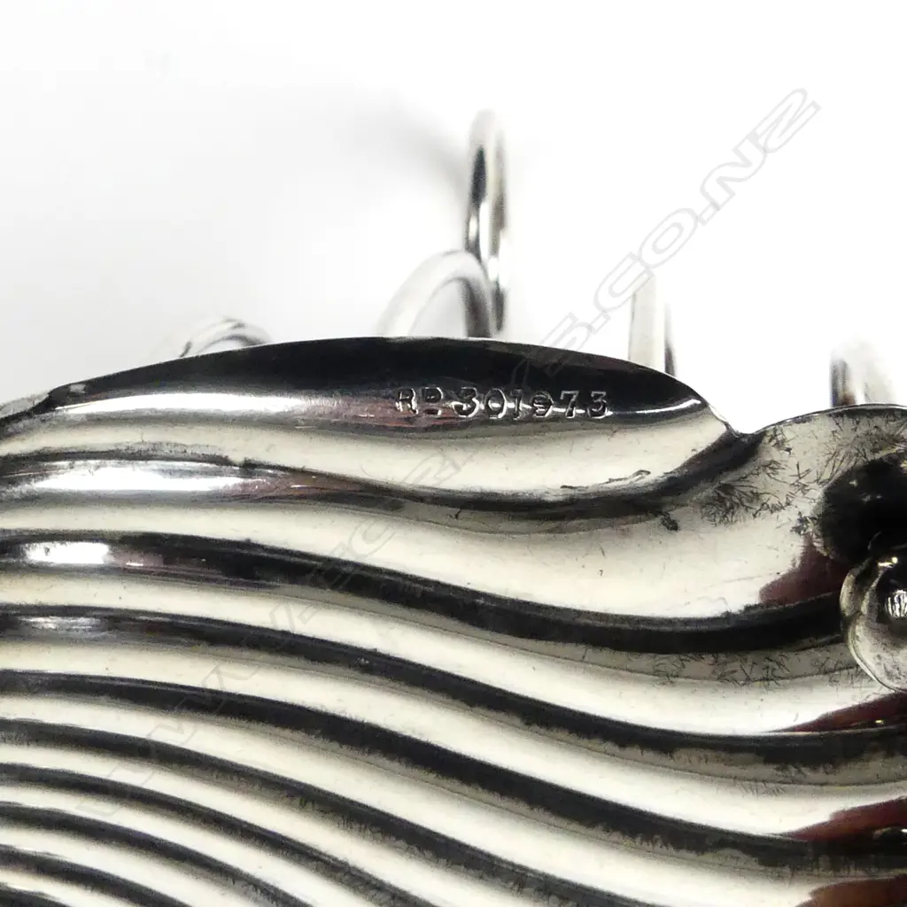 An Edwardian silver four-slice toast rack Image 1++